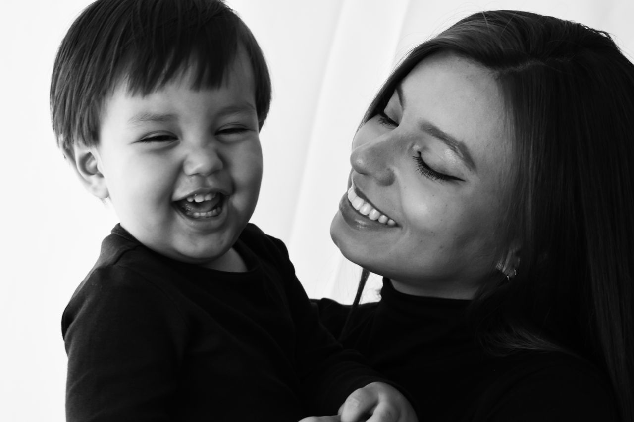 A joyful black and white portrait capturing a mother and child's happy moments.